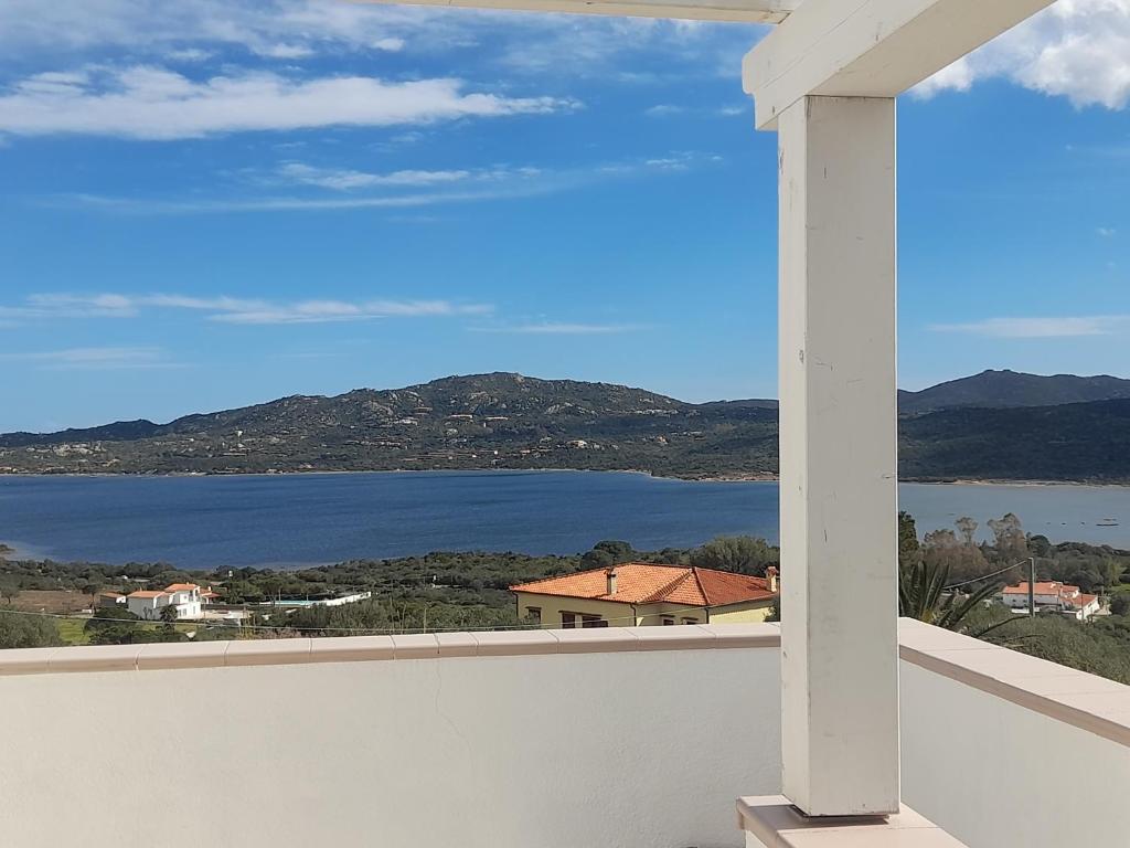 a view of the water from the balcony of a house at Villa Ginepro in Olbia