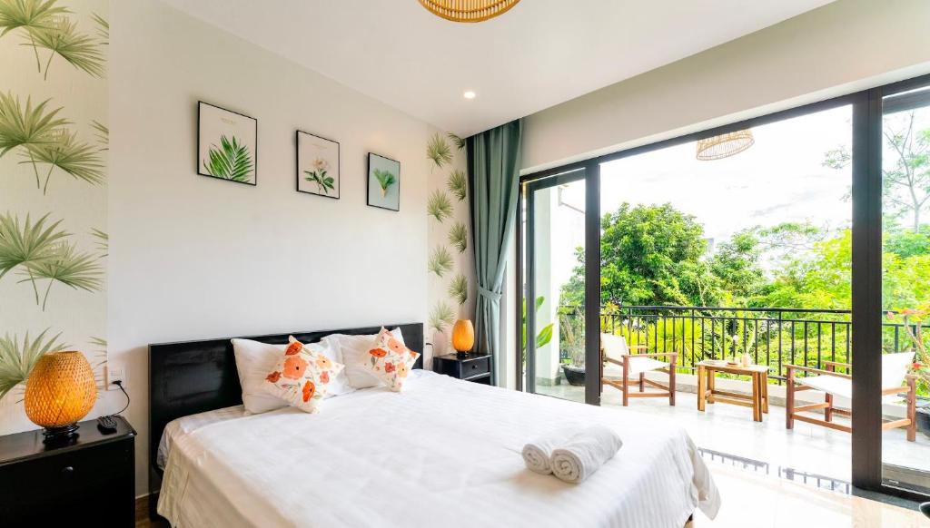 Postel nebo postele na pokoji v ubytování Luna Verde Hotel Hoi An