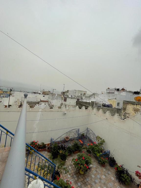 a view of a balcony with flowers on a building at Dar Mora in Tangier