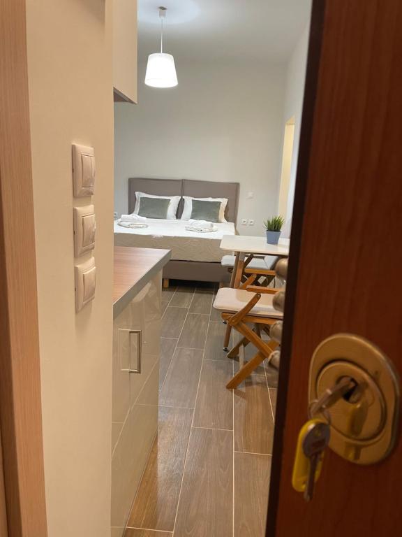 a door to a room with a bed and a table at Cute studio near acropolis in Athens