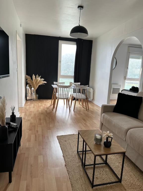 uma sala de estar com um sofá e uma mesa em Appartement vue sur mer em Plérin