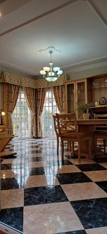 a dining room with a table and a checkered floor at piso en arenas de velez malaga in Málaga