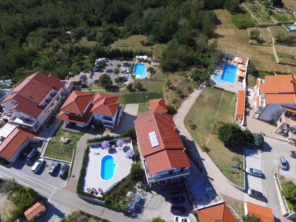 an aerial view of a house with two swimming pools at Guesthouse Marija II in Lopar