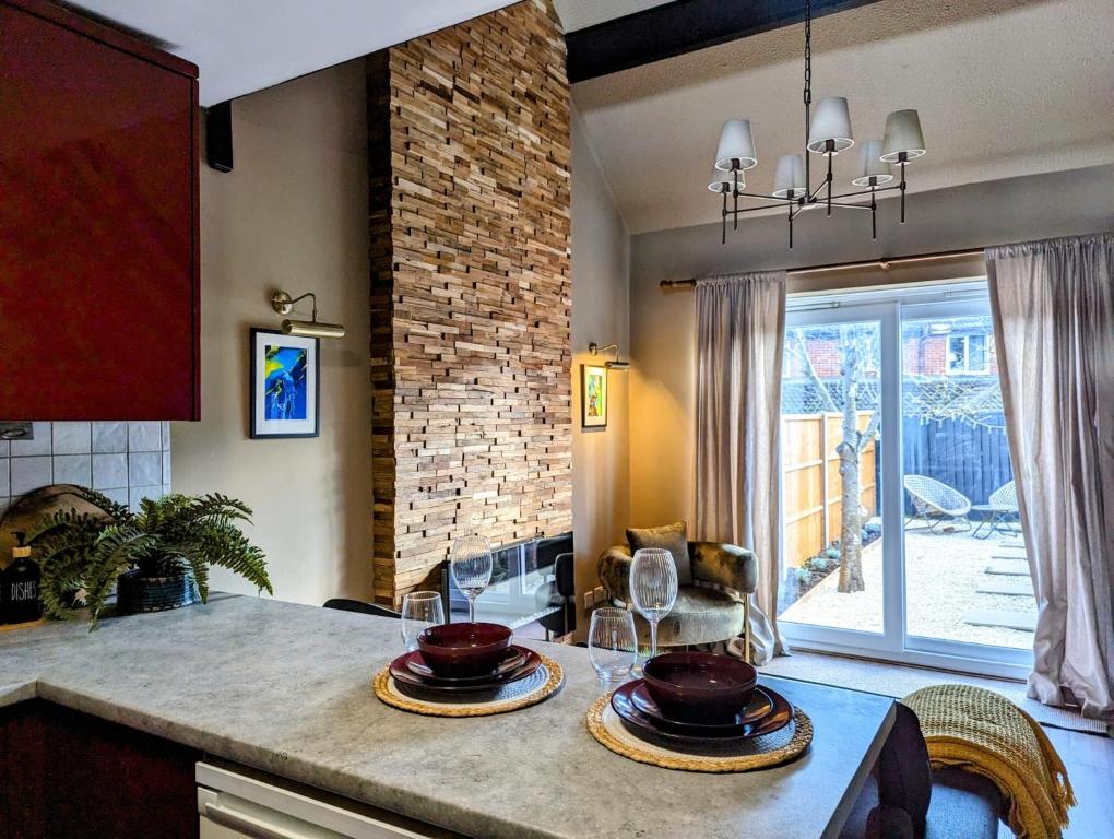 a kitchen with two plates on a counter with a window at New, unique, tiny house with garden in Wigston Magna