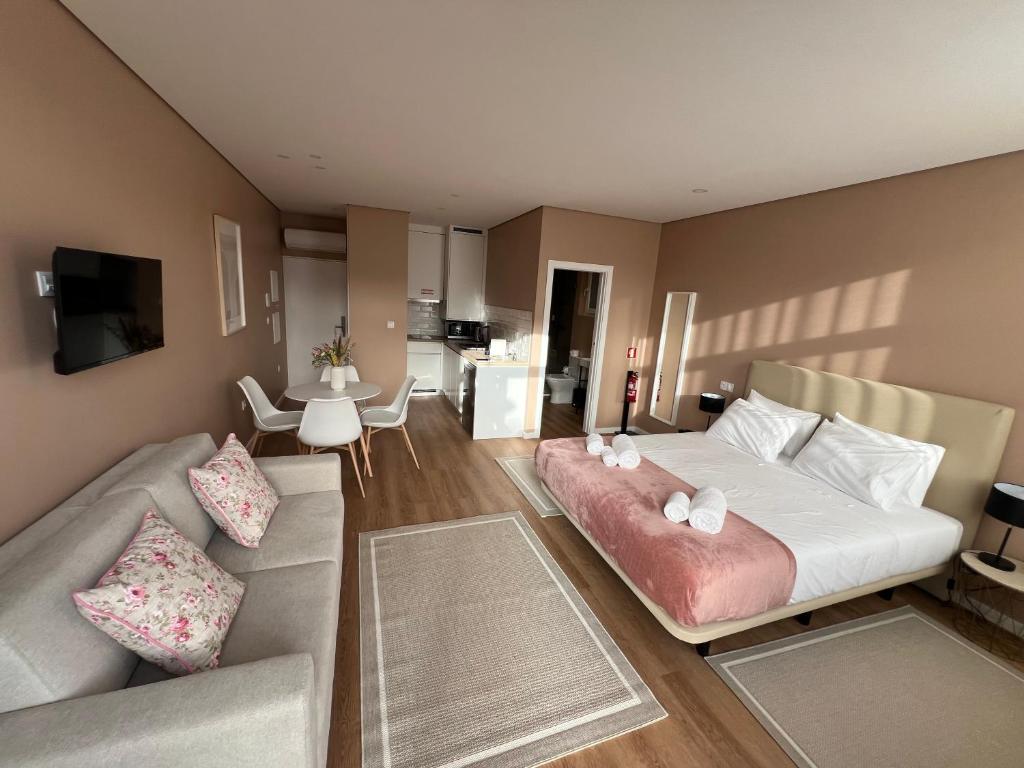 a living room with a bed and a couch at Primeiro Quartel Apartments - 3 in Peso da Régua