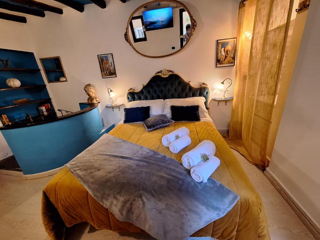a bedroom with a large bed with two towels at Ωlimpiα Apartment in Rome