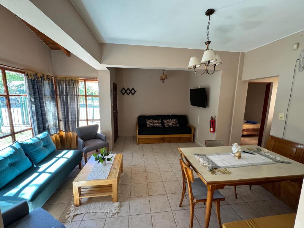 a living room with a blue couch and a table at Casa Tilo in El Bolsón