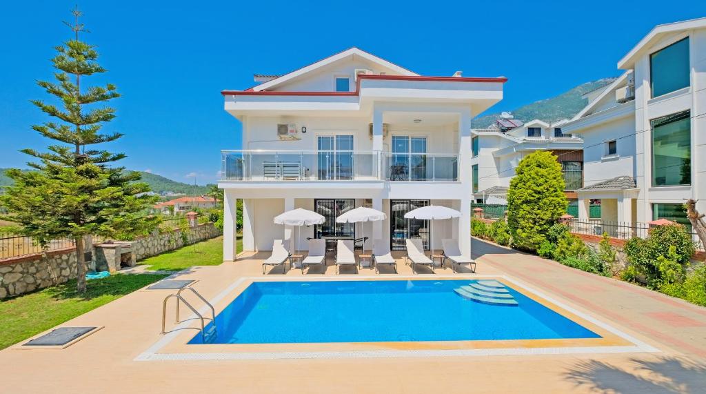 a villa with a swimming pool and a house at Villa Lucia in Fethiye
