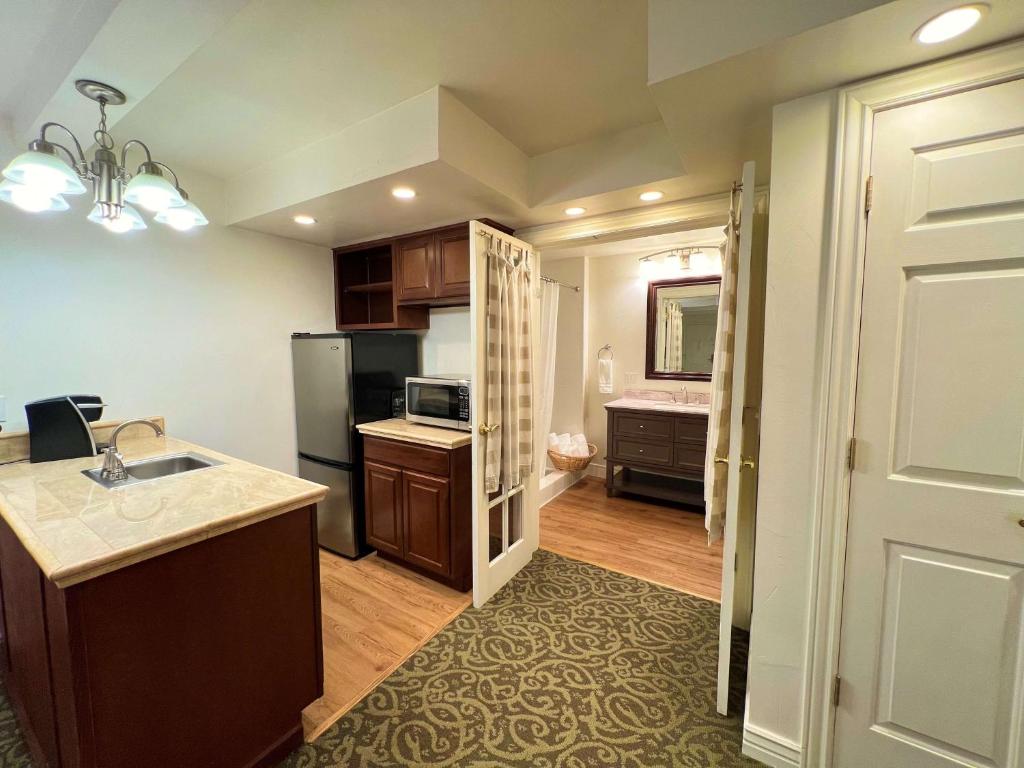 a kitchen with a sink and a refrigerator at Best Western Country Lane Inn in Mendenhaven