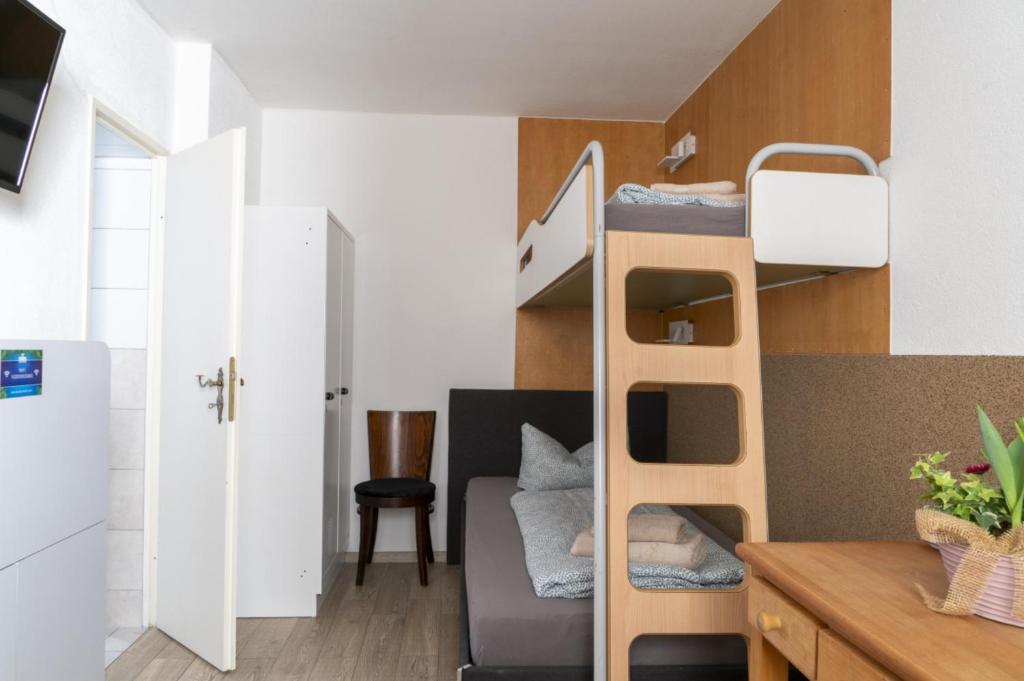 a small apartment with a bunk bed in a room at Hostel Senftenberg in Senftenberg