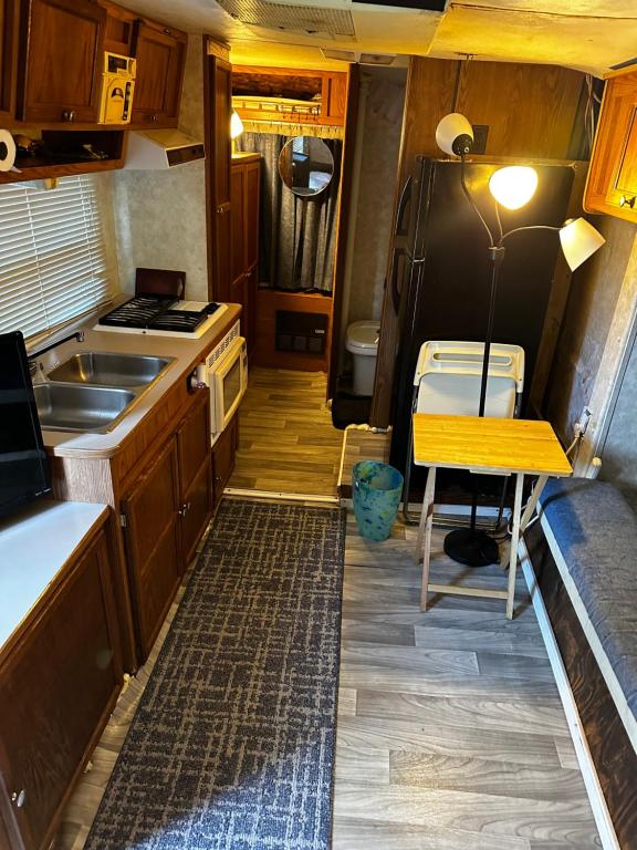 a kitchen with a table and a stove and a refrigerator at Black castle RV2 in Miami