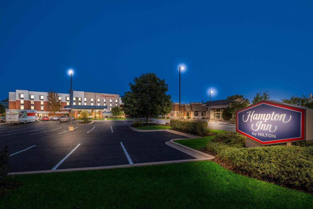 a parking lot with a sign for a chiropractor clinic at Hampton Inn McHenry in McHenry