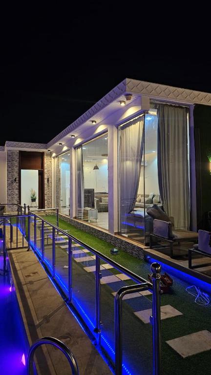 a house with a swimming pool at night at شاليهات بيوتي in Umm Salam