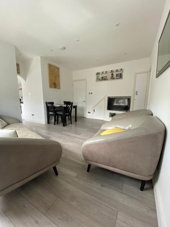 a living room with two beds and a dining room at Modern 3 bed flat near Crystal Palace Stadium with great transport links in Norwood