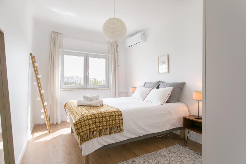 En eller flere senge i et værelse på Apartamento central Setúbal sossegado e com luz