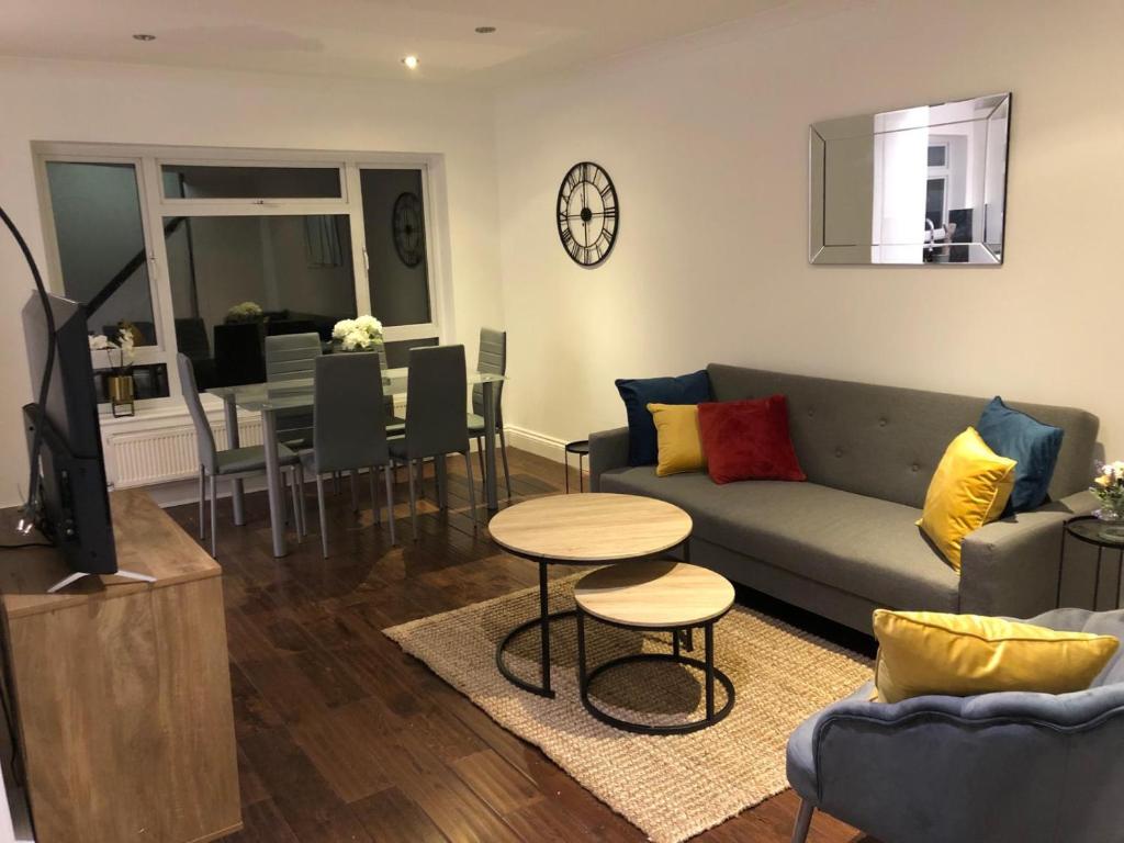 a living room with a couch and a table at Mill Hill Modern 3 Bedroom Apartment in Mill Hill