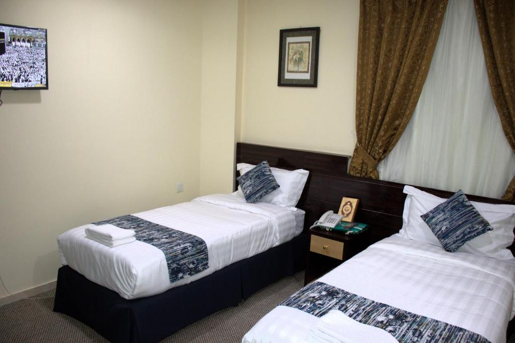 Postel nebo postele na pokoji v ubytování فندق لؤلؤة العنود مكة توصيل مجانا للحرم - Loulouat Al Anood Hotel Makkah Free shuttle service