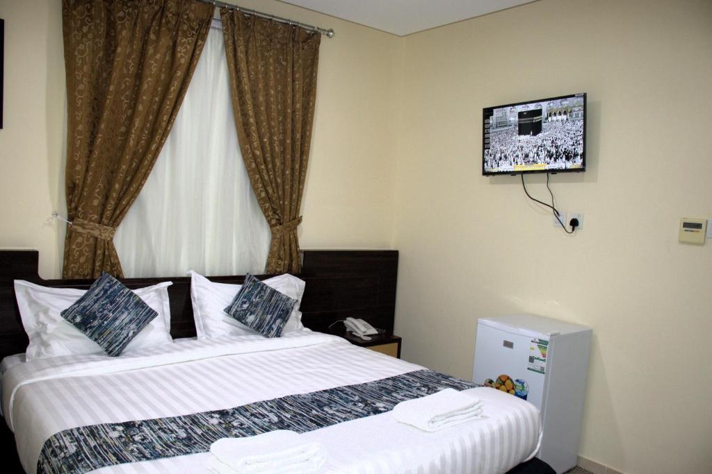 Postel nebo postele na pokoji v ubytování فندق لؤلؤة العنود مكة توصيل مجانا للحرم - Loulouat Al Anood Hotel Makkah Free shuttle service