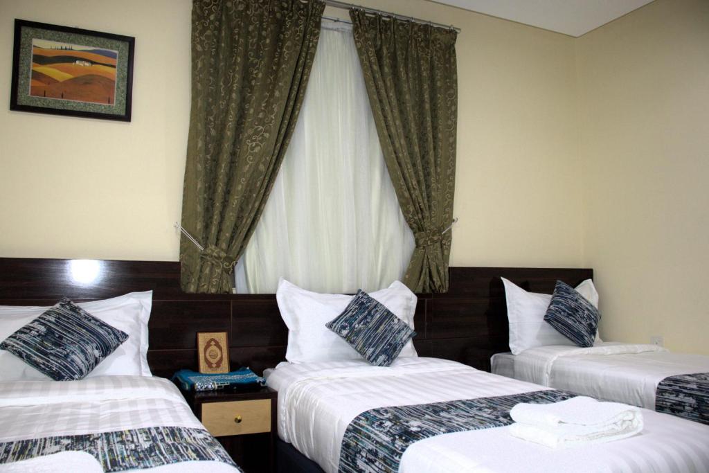 Postel nebo postele na pokoji v ubytování فندق لؤلؤة العنود مكة توصيل مجانا للحرم - Loulouat Al Anood Hotel Makkah Free shuttle service