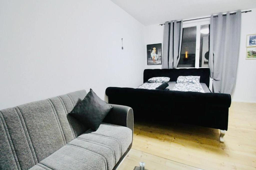 a living room with a couch and a bed at Modern Apartment in Millennium City Area in Vienna