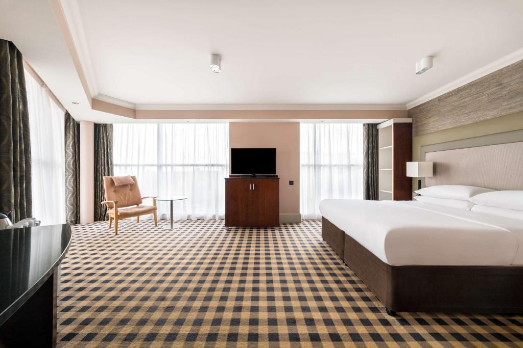 a hotel room with a bed and a television at DoubleTree by Hilton Hotel Newcastle International Airport in Newcastle upon Tyne