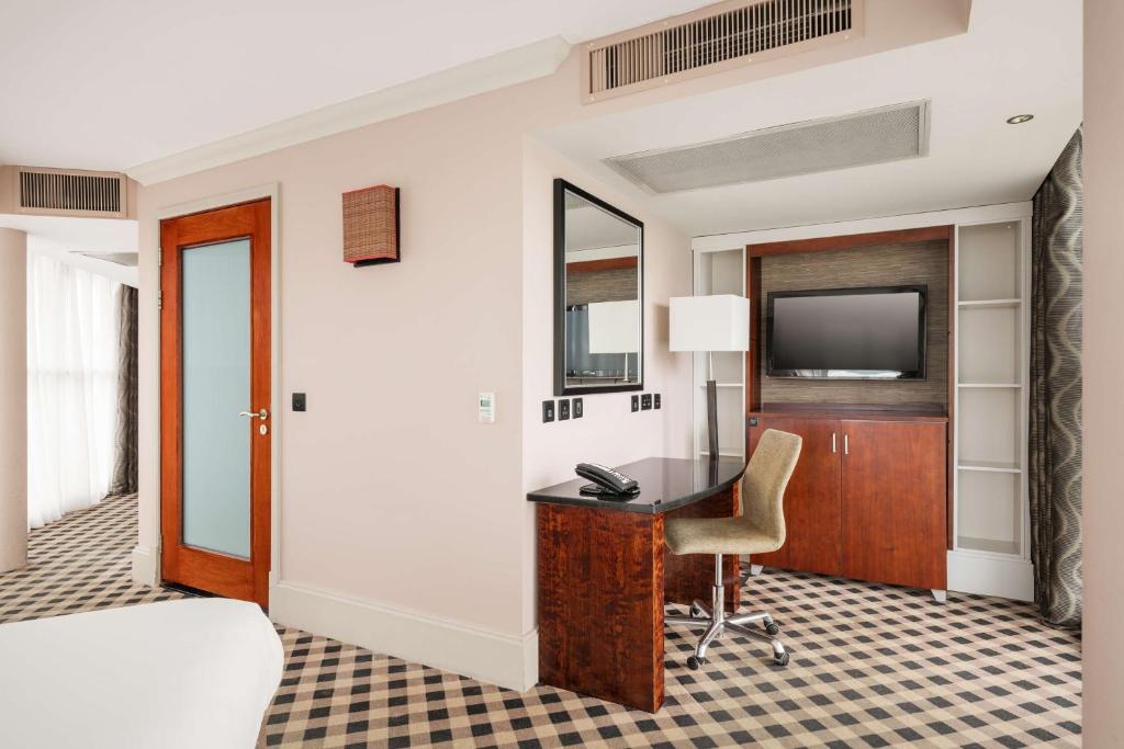 a hotel room with a desk and a television at DoubleTree by Hilton Hotel Newcastle International Airport in Newcastle upon Tyne