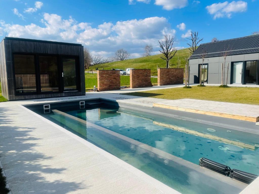 a swimming pool in a yard with a house at Luxury Holiday House BREJZOV BREJG in Dankovci