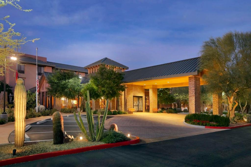 a building with a courtyard with trees and plants at Hilton Garden Inn Scottsdale North/Perimeter Center in Scottsdale