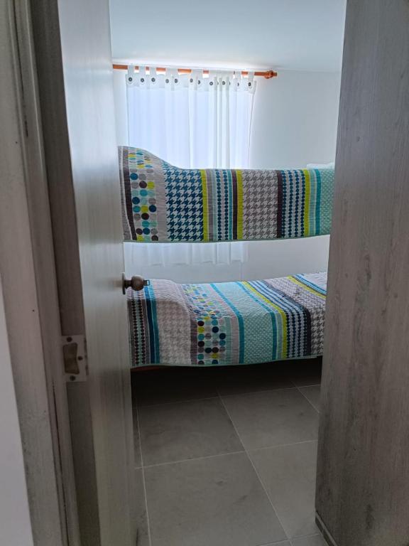 Postel nebo postele na pokoji v ubytování Tiziano apartamento 504