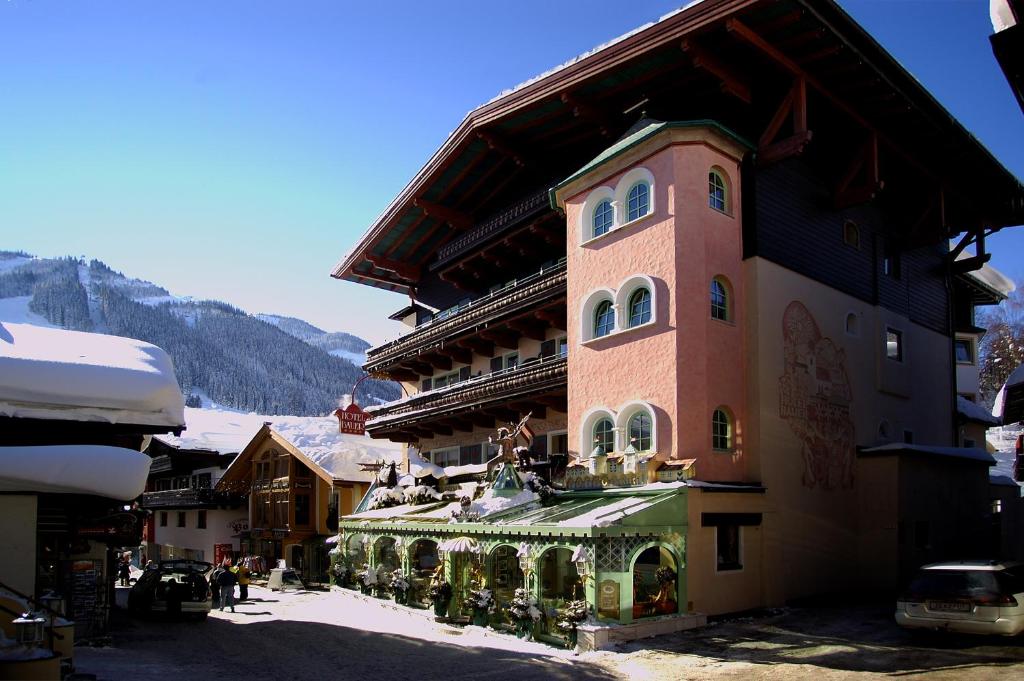 a large building with christmas decorations on the side of it at Boutique-Hotel Bauer in Saalbach Hinterglemm