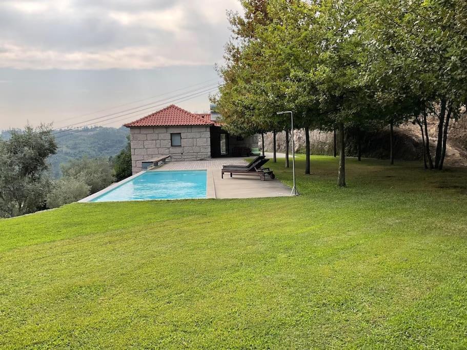 a swimming pool in a yard with a house at Casa da Prelada in Amarante