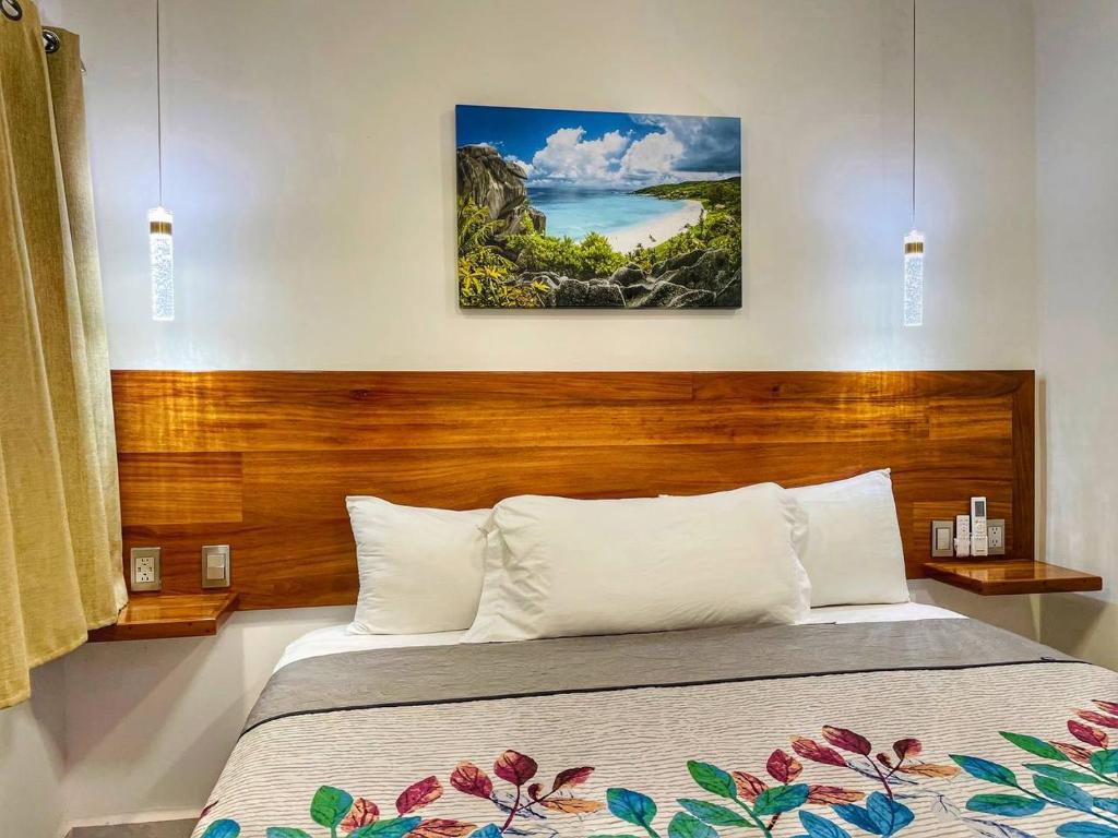 a bedroom with a bed with a wooden headboard at CASA SAN AGUSTÍN #4 in Puerto Escondido
