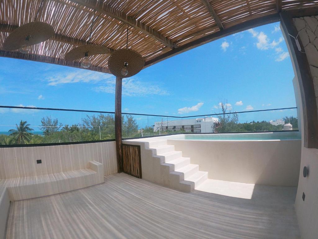 a balcony with a view of the sky at Casa Hood By the Sea in Holbox Island