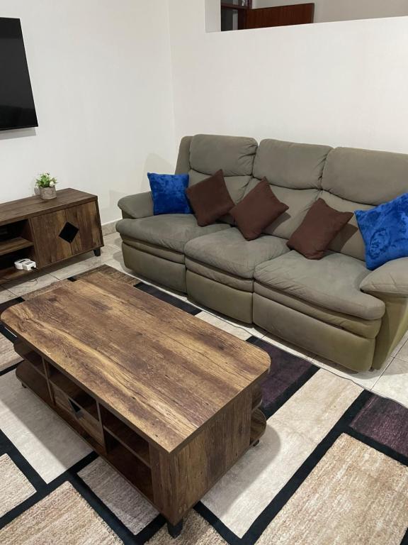 a living room with a couch and a coffee table at Kisumu 3 bedroom Apartment Elegant in Kisumu
