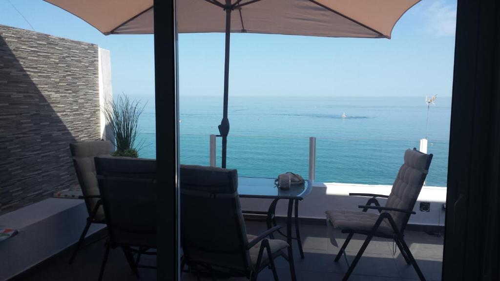 tavolo e sedie con vista sull'oceano di Beachfront Bungalow Apartment a Torremolinos