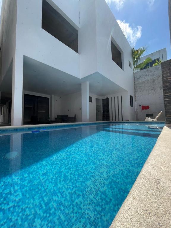 a swimming pool in front of a house at Alce33 in Cancún