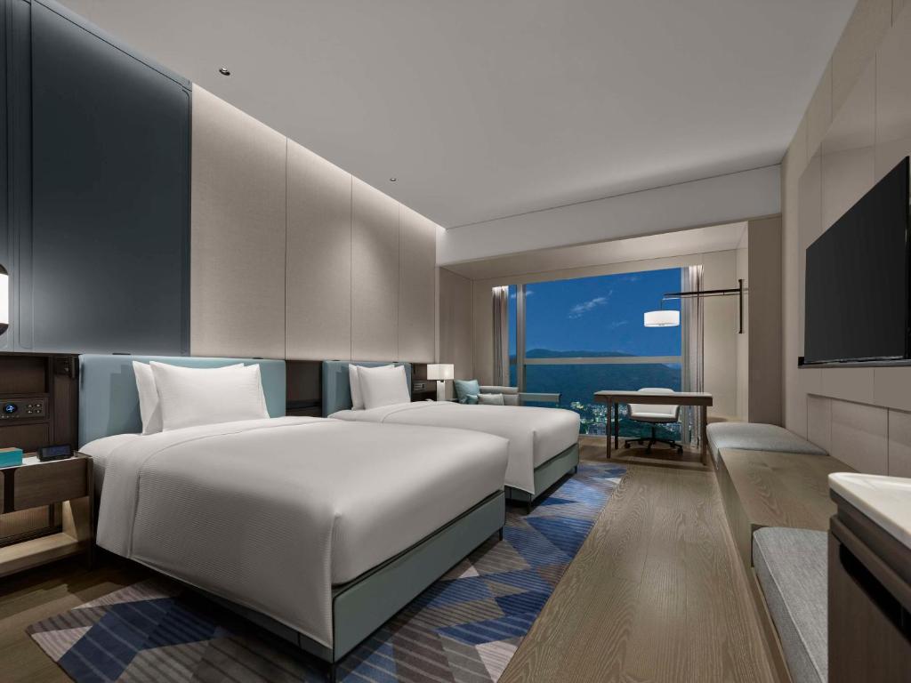 Postel nebo postele na pokoji v ubytování Hilton Zhuhai