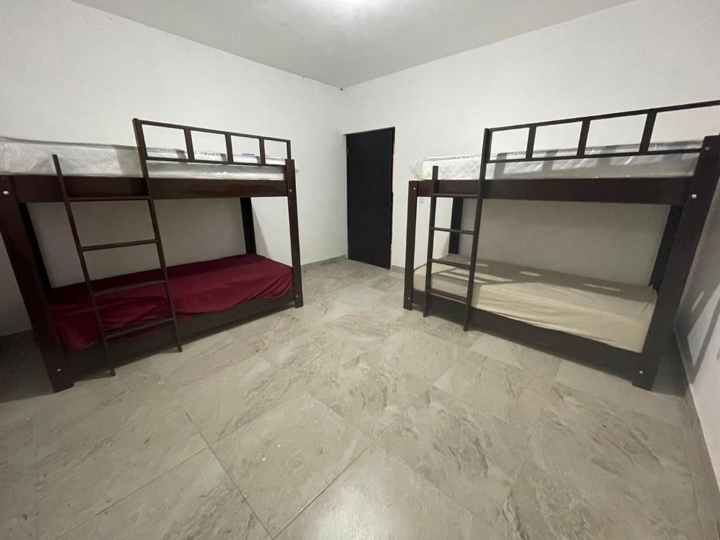 two bunk beds in a room with a tile floor at Casa de las estrellas in Valles