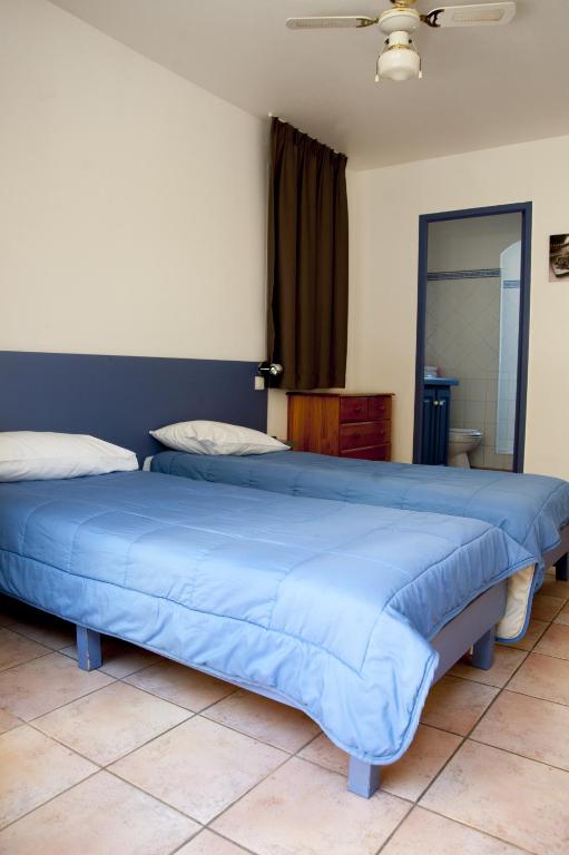Postel nebo postele na pokoji v ubytování Hôtel Le Leukos