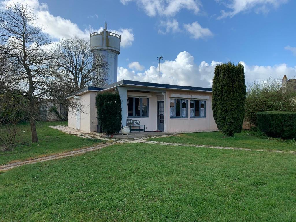 a small house with a lighthouse on top of it at Maison Familiale au Calme Proche Baie d'Authie - 2 Chambres, Jardin, Stationnement - FR-1-482-137 in Fort-Mahon-Plage