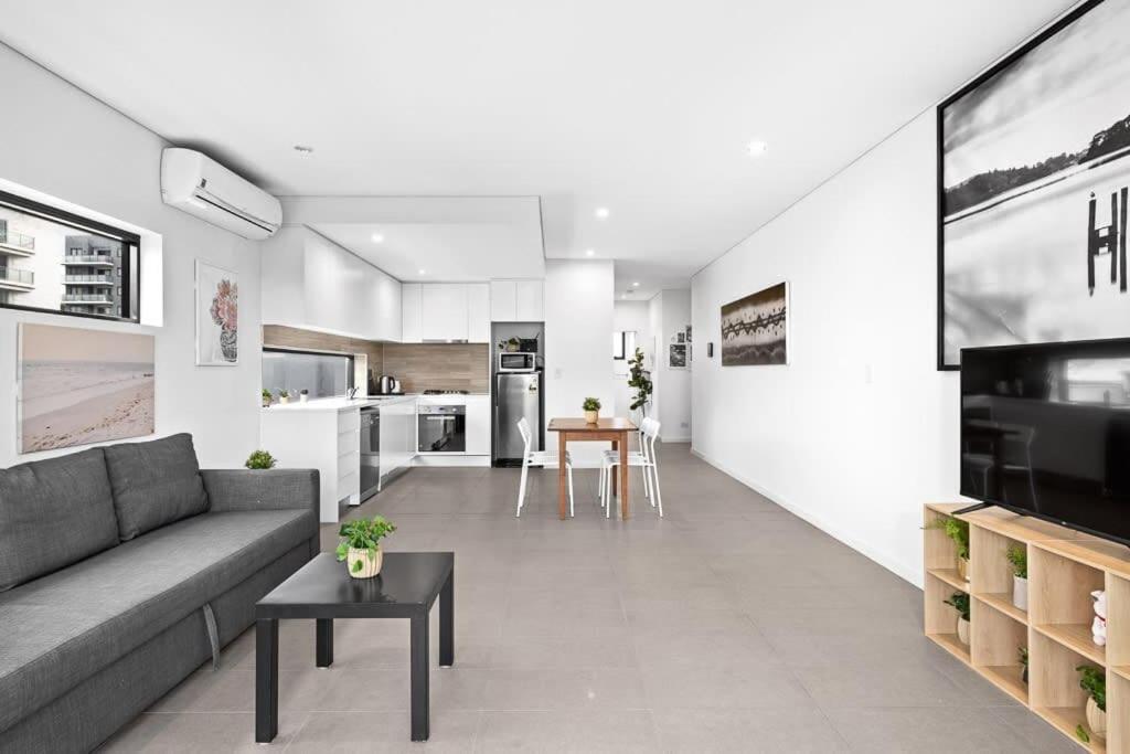 a living room with a couch and a table at New Modern 2BR 2baths Apt in Homebush Sleeps 6 in Sydney