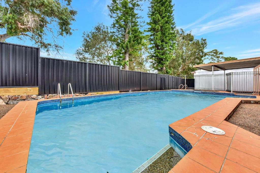 una piscina en un patio trasero con una valla en Good Vibes Bayside - Lake Foreshore with Private Pool, en Teralba