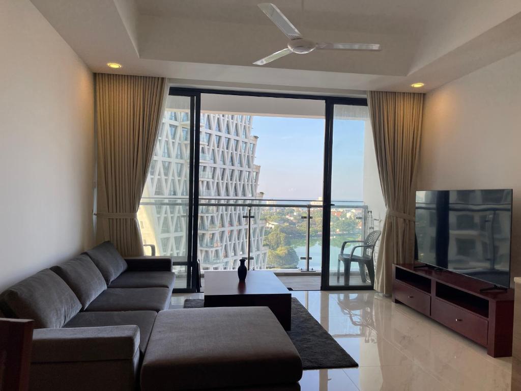a living room with a couch and a large window at Peak of Colombo in Colombo