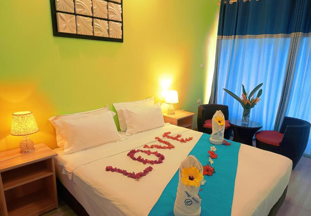 a hotel room with a bed with flowers on it at Nadi Fancy Hotel in Nadi