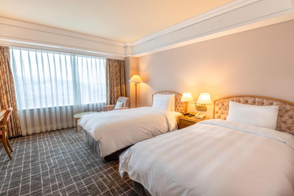 Postel nebo postele na pokoji v ubytování Lotte Hotel Busan