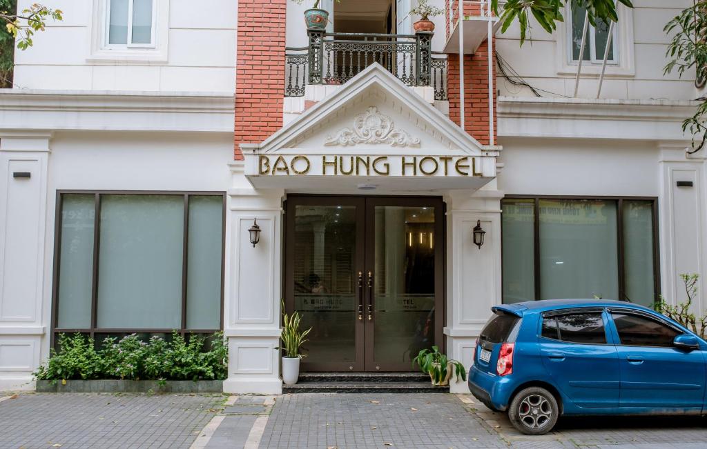 un coche azul estacionado frente a un hotel colgado de una bolsa en Bảo Hưng Hotel en Thanh Hóa