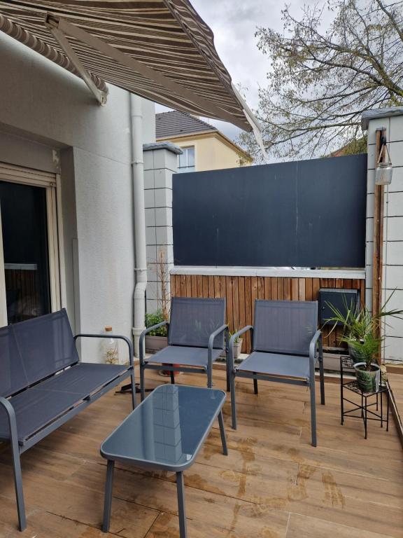 a group of blue benches sitting on a patio at F2 type apartment Near Stade de France in Saint-Denis