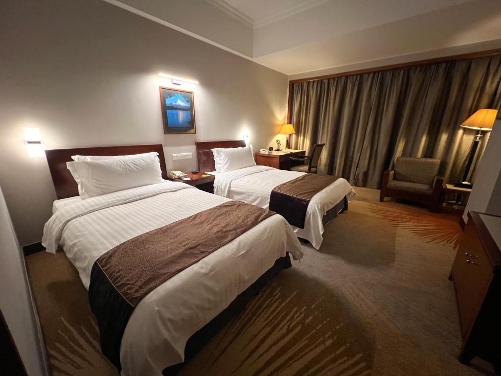 Postel nebo postele na pokoji v ubytování Baolong Hotel Shanghai