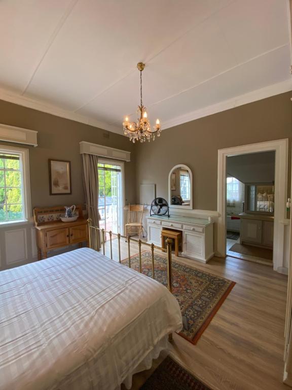 a bedroom with a bed and a desk at Garden Court in Potchefstroom