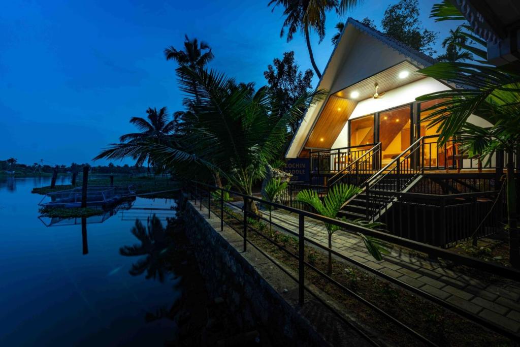a house on the water at night at Liara Fish Net Villa in Elūr